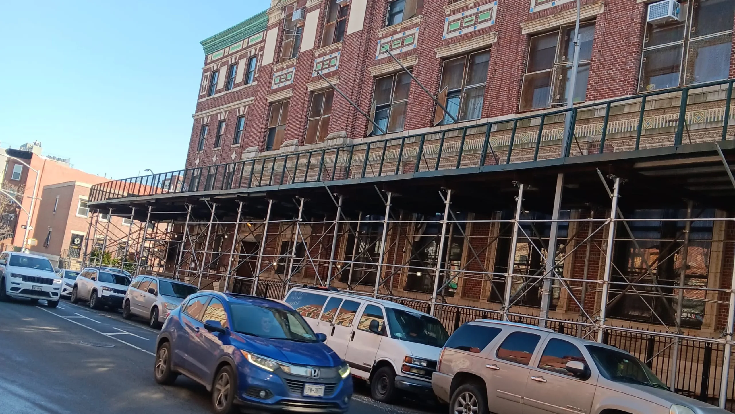 Sidewalk shed protecting pedestrians along a busy street during an event in Rockville Centre, ensuring safe passage beside a construction site