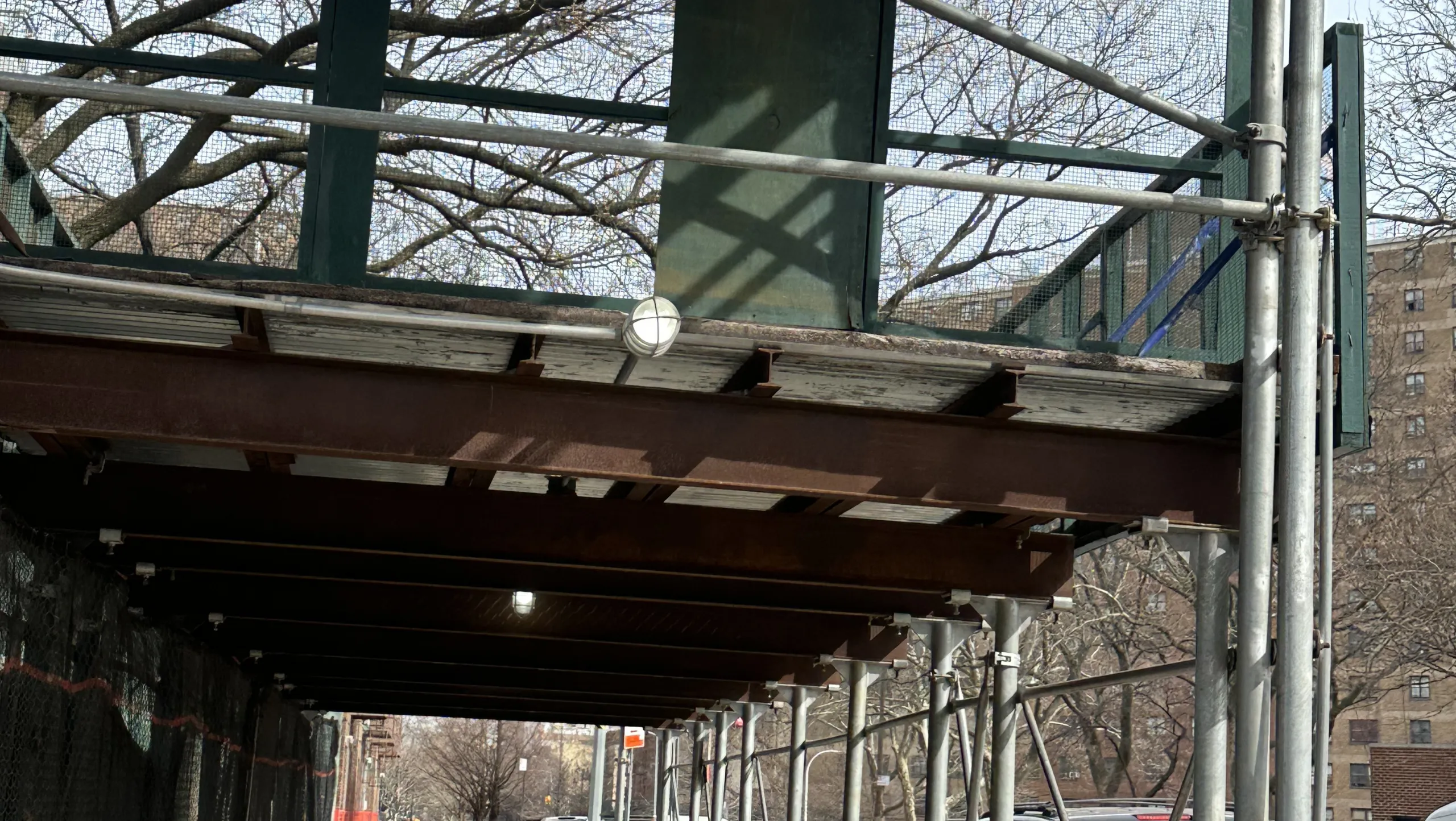 Scaffolding and sidewalk shed system protecting pedestrians from falling debris on a busy Nassau County street