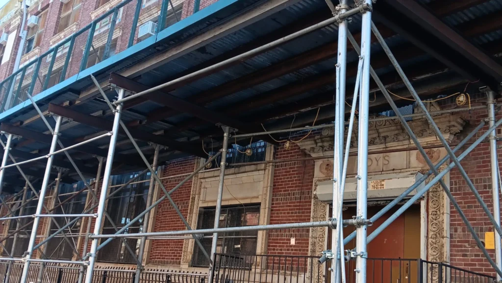 Temporary sidewalk shed and scaffolding setup along urban building for safety and compliance in Long Island